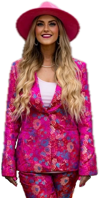 Stefanie Couch smiling in a pink hat and a magenta floral suit