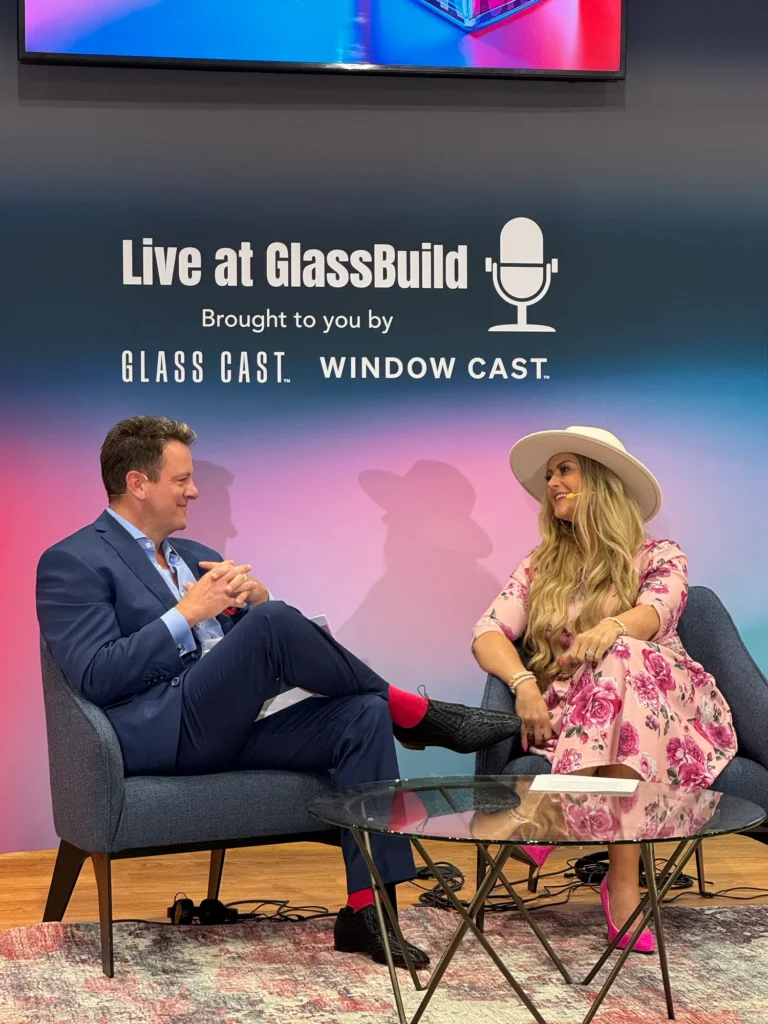 Stefanie Couch recording a Live at GlassBuild podcast interview with a guest at GlassBuild America 2025