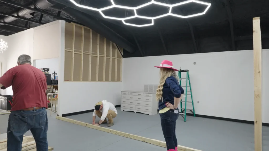 Stefanie Couch helping frame walls inside Grit Studios
