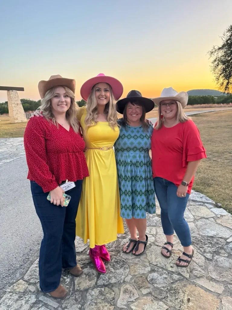 Stefanie Couch with a group of women at sunset at the Nation’s Best Women’s Leadership Retreat