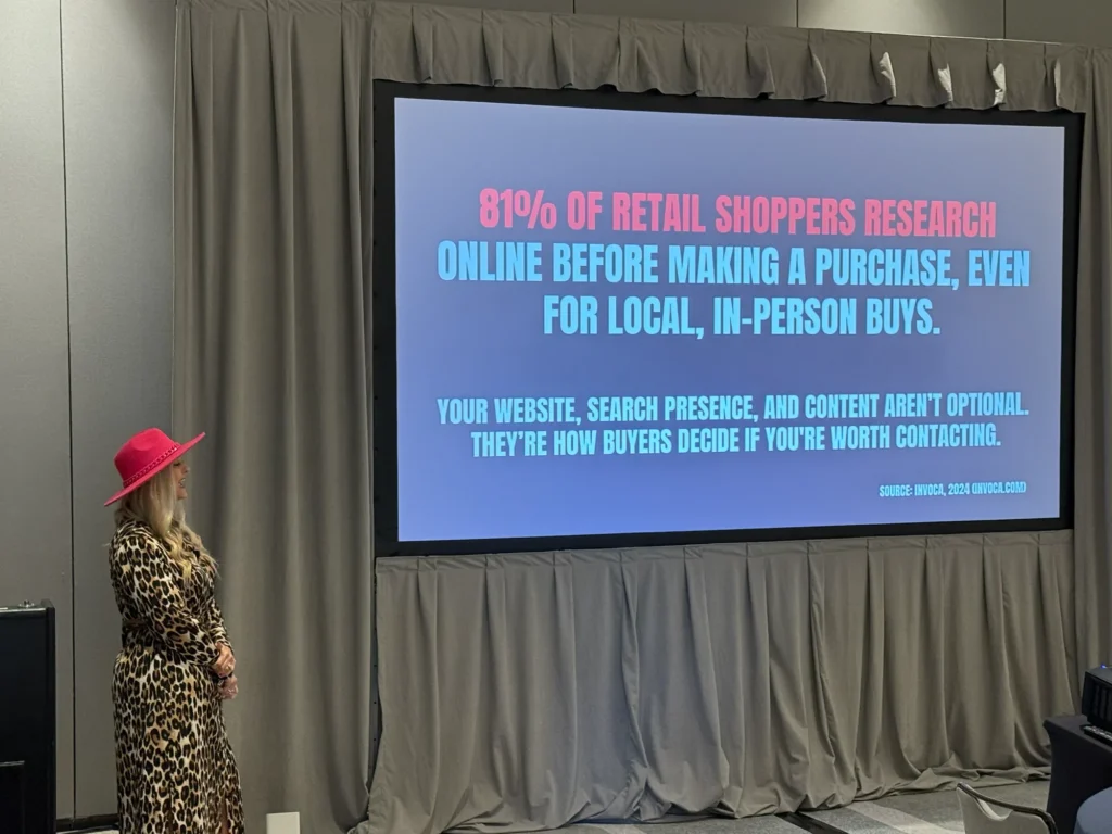 Stefanie Couch presenting beside the screen in a hotel ballroom