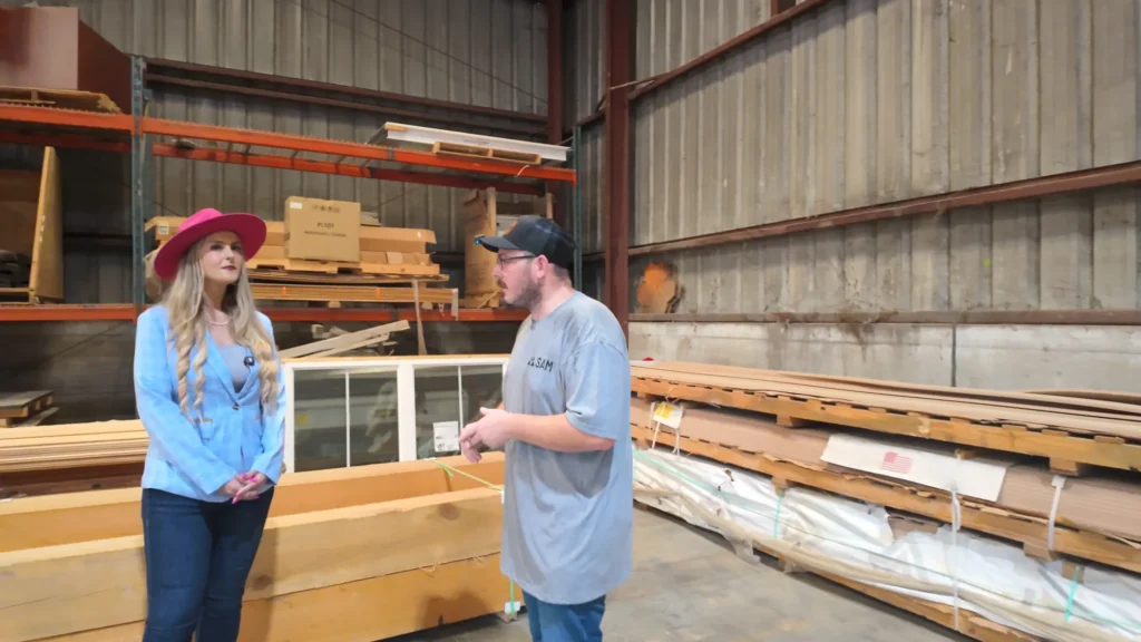 Stefanie Couch talking with a guest by the lumber racks at SAM
