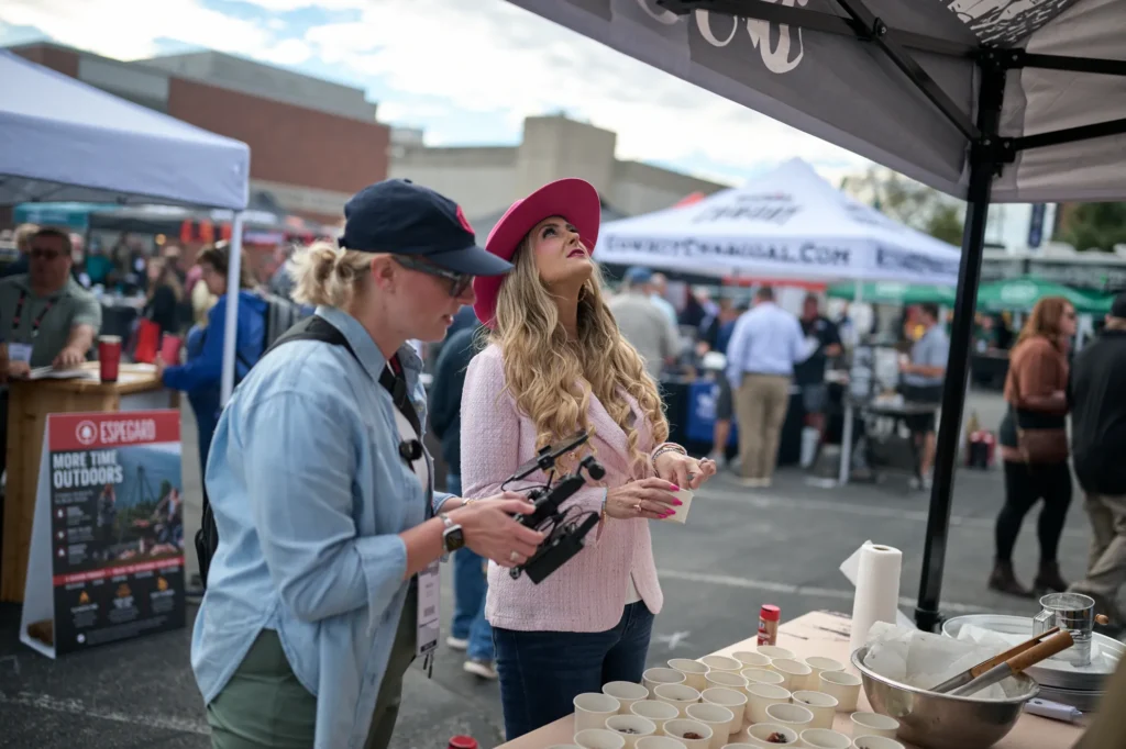 A Grit Blueprint camera operator films Stefanie Couch in the outdoor vendor area at Do it Best Fall Market 2026