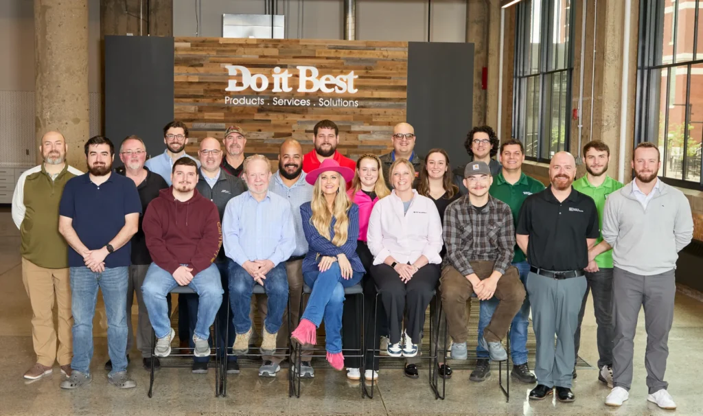 The Do it Best LBM Millwork Academy class with Stefanie Couch in front of the Do it Best sign