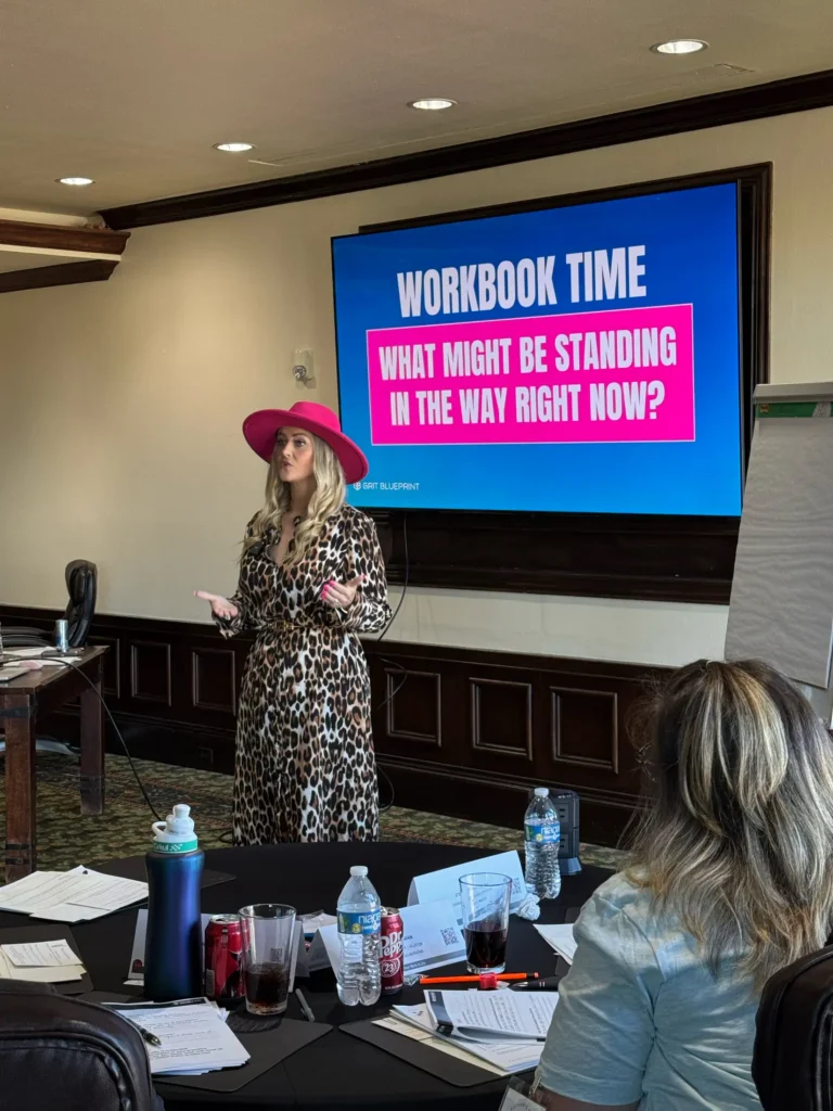 Stefanie Couch speaks beside a Workbook Time slide during her session at the Nation’s Best Women’s Leadership Retreat
