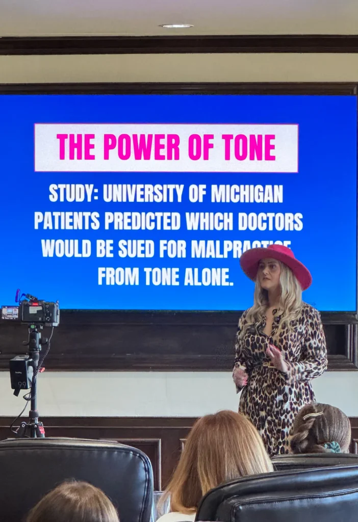 Stefanie Couch speaks in front of a Power of Tone slide at the Nation’s Best Women’s Leadership Retreat