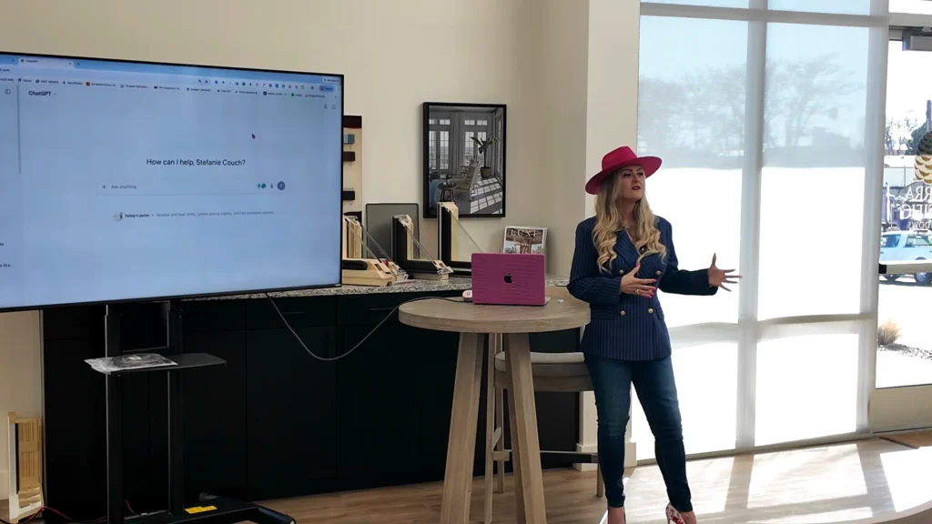 Stefanie Couch teaching an AI session for Sierra Pacific Windows contractors beside a large screen